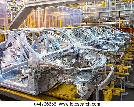 Stock Photograph - Car bodies on production line in car factory. Fotosearch