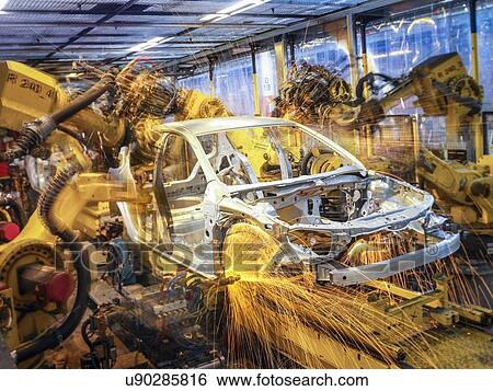 Stock Photograph - Car body being welded on production line in car factory. Fotosearch
