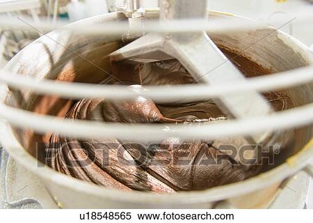 Stock Photography - "Chocolate in mixer in cake factory, close up". Fotosearch