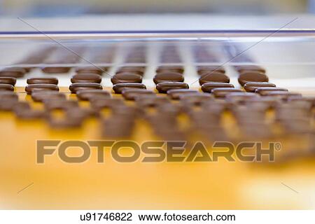 Chocolates on production line in chocolate factory View Large Photo Image Stock Image - Chocolates on production line in chocolate factory. Fotosearch