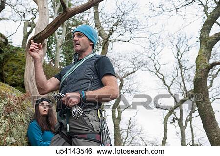 "Climbing instructor talking, young woman listening" View Large Photo Image Stock Photograph - "Climbing instructor talking, young woman listening". Fotosearch