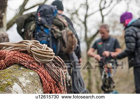 Stock Image - Climbing ropes on rocks with climbers in background. Fotosearch