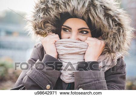 Close up of beautiful young woman in park holding up scarf in front of face View Large Photo Image Stock Image - Close up of beautiful young woman in park holding up scarf in front of face. Fotosearch