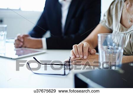 Close up of businessman and woman at conference table View Large Photo Image Stock Photo - Close up of businessman and woman at conference table. Fotosearch