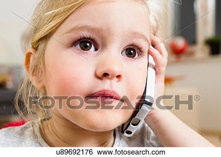 Stock Photograph - Close up of girl with smartphone. Fotosearch