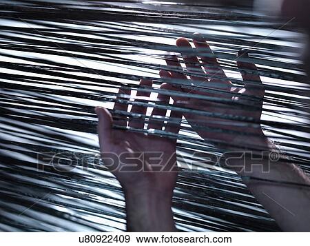 Stock Photo - Close up of hands holding carbon fibre on loom in carbon fibre factory. Fotosearch