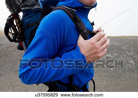 Stock Photo - "Close up of male hiker carrying backpack, Kleine Scheidegg, Grindelwald, Switzerland". Fotosearch