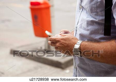 "Close up of man texting on smartphone, Copacabana town, Rio De Janeiro, Brazil" View Large Photo Image Stock Photo - "Close up of man texting on smartphone, Copacabana town, Rio De Janeiro, Brazil". Fotosearch