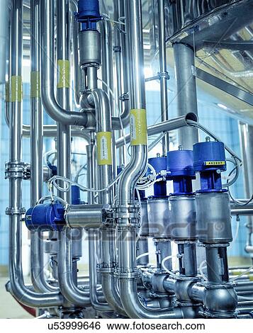Stock Photograph - Close up of pipes and connections in brewery. Fotosearch