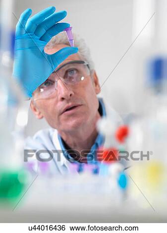 Close up of scientist holding a phial containing a DNA sample View Large Photo Image Stock Photograph - Close up of scientist holding a phial containing a DNA sample. Fotosearch