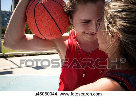 Picture - Close up of young couple at basketball court. Fotosearch