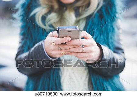 "Close up of young woman texting on smartphone, Lake Como, Como, Italy" View Large Photo Image Stock Image - "Close up of young woman texting on smartphone, Lake Como, Como, Italy". Fotosearch