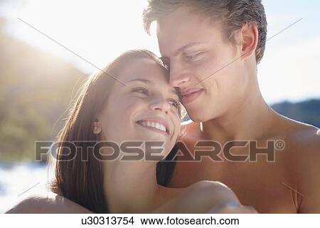 "Close up portrait of bare shouldered young couple at lakeside, German Alps, Germany" View Large Photo Image Picture - "Close up portrait of bare shouldered young couple at lakeside, German Alps, Germany". Fotosearch