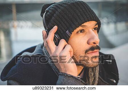 Close up portrait of businessman listening to headphones View Large Photo Image Stock Image - Close up portrait of businessman listening to headphones. Fotosearch