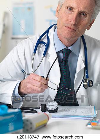 Stock Photo - Close up portrait of doctor consulting a patient in office. Fotosearch