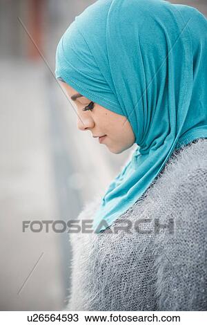 Close up portrait of young woman wearing turquoise hijab on footbridge View Large Photo Image Stock Image - Close up portrait of young woman wearing turquoise hijab on footbridge. Fotosearch