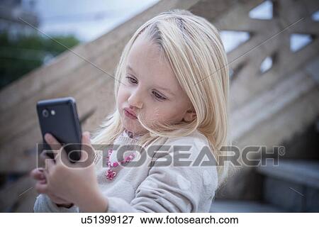"Confused young girl on stairway using smartphone, Cagliari, Sardinia, Italy" View Large Photo Image Stock Photo - "Confused young girl on stairway using smartphone, Cagliari, Sardinia, Italy". Fotosearch