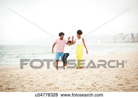 Stock Photo - "Couple and son enjoying beach, Rio de Janeiro, Brazil". Fotosearch