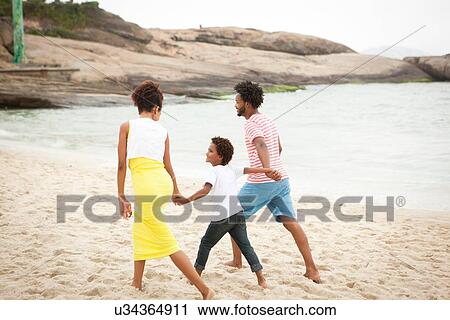 Couple and son enjoying beach View Large Photo Image Stock Image - Couple and son enjoying beach. Fotosearch