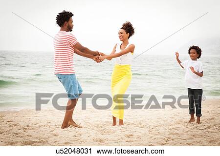 Couple and son enjoying beach View Large Photo Image Stock Image - Couple and son enjoying beach. Fotosearch