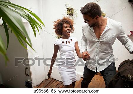"Couple arriving into apartment, holding hands" View Large Photo Image Stock Photography - "Couple arriving into apartment, holding hands". Fotosearch