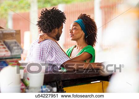 Stock Image - "Couple at beach bar, Ipanema beach, Rio De Janeiro, Brazil". Fotosearch