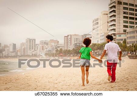 Stock Photography - "Couple enjoying beach, Rio de Janeiro, Brazil". Fotosearch