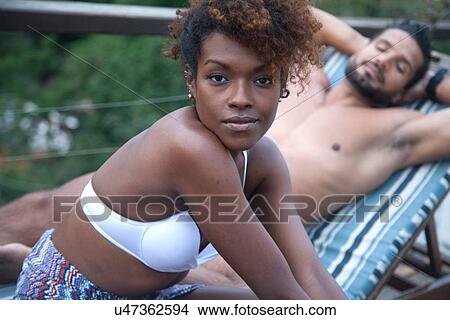 Couple enjoying swimming pool View Large Photo Image Picture - Couple enjoying swimming pool. Fotosearch