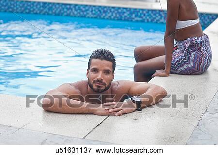 Couple enjoying swimming pool View Large Photo Image Stock Photo - Couple enjoying swimming pool. Fotosearch