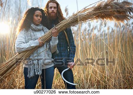 Couple harvesting wheat with scythe View Large Photo Image Stock Photograph - Couple harvesting wheat with scythe. Fotosearch