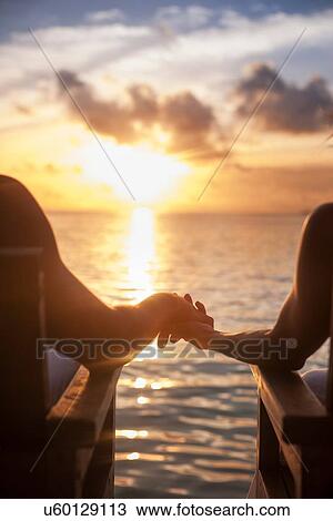 Couple holding hands on vacation View Large Photo Image Stock Image - Couple holding hands on vacation. Fotosearch