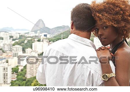 "Couple on terrace, Sugarloaf Mountain in background, Rio, Brazil" View Large Photo Image Stock Image - "Couple on terrace, Sugarloaf Mountain in background, Rio, Brazil". Fotosearch