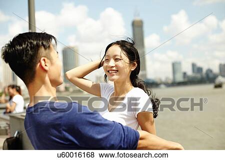 Stock Photo - "Couple sight seeing on waterfront, The Bund, Shanghai, China". Fotosearch