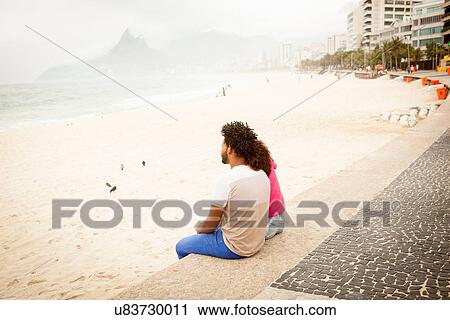 "Couple sitting looking out from Ipanema beach, Rio De Janeiro, Brazil" View Large Photo Image Stock Image - "Couple sitting looking out from Ipanema beach, Rio De Janeiro, Brazil". Fotosearch