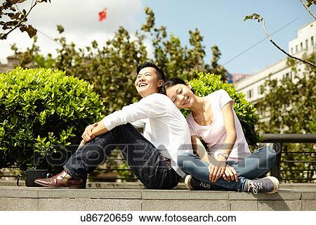 "Couple sitting on wall, The Bund, Shanghai, China" View Large Photo Image Stock Photo - "Couple sitting on wall, The Bund, Shanghai, China". Fotosearch