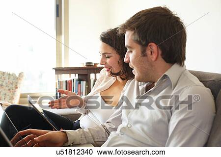 Couple surfing the web at home View Large Photo Image Stock Image - Couple surfing the web at home. Fotosearch