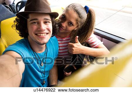 "Couple taking selfie on bus, Rio de Janeiro, Brazil" View Large Photo Image Stock Image - "Couple taking selfie on bus, Rio de Janeiro, Brazil". Fotosearch