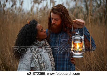 Couple using paraffin lamp in countryside View Large Photo Image Stock Photography - Couple using paraffin lamp in countryside. Fotosearch