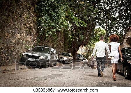 "Couple walking on street, holding hands" View Large Photo Image Stock Photo - "Couple walking on street, holding hands". Fotosearch