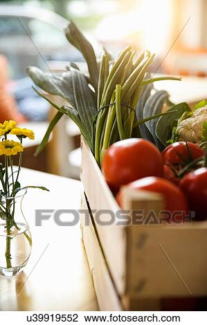 Stock Image - Crate of tomatoes and vegetables. Fotosearch