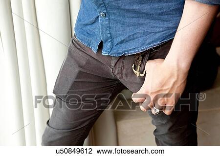 Cropped close up of young man with hand in jeans pocket View Large Photo Image Stock Image - Cropped close up of young man with hand in jeans pocket. Fotosearch