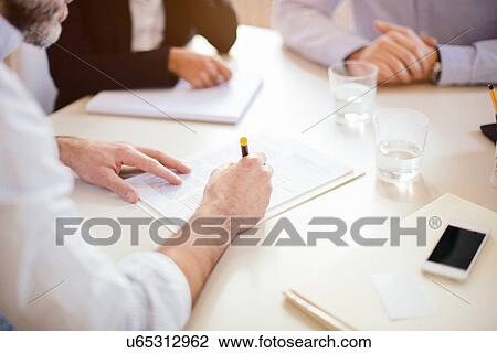 Cropped over the shoulder view of businessman signing contract View Large Photo Image Stock Image - Cropped over the shoulder view of businessman signing contract. Fotosearch