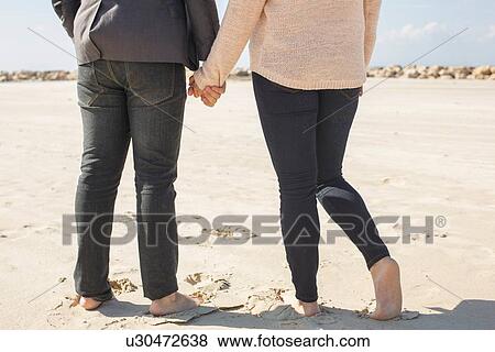 "Cropped rear view of barefoot young couple on beach, Tel Aviv, Israel" View Large Photo Image Stock Photo - "Cropped rear view of barefoot young couple on beach, Tel Aviv, Israel". Fotosearch