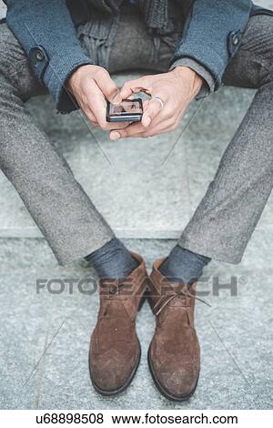 Stock Photo - Cropped shot of businessman texting on smartphone. Fotosearch