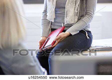 Cropped shot of two businesswomen at office desk View Large Photo Image Stock Image - Cropped shot of two businesswomen at office desk. Fotosearch
