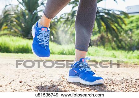 Cropped shot of womans legs running on dirt track in park View Large Photo Image Stock Photo - Cropped shot of womans legs running on dirt track in park. Fotosearch