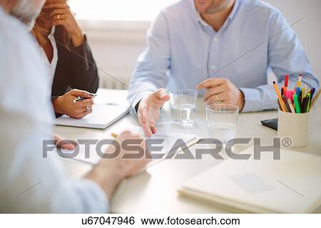Cropped view of businessman signing contract at boardroom table View Large Photo Image Stock Photograph - Cropped view of businessman signing contract at boardroom table. Fotosearch