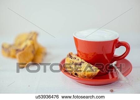 Stock Photograph - Cup of latte and chocolate cantucci biscuits. Fotosearch