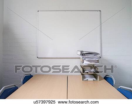 Desks and paperwork in empty meeting room View Large Photo Image Stock Photography - Desks and paperwork in empty meeting room. Fotosearch