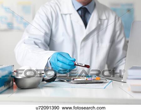 Doctor preparing patients blood urine and other samples for testing View Large Photo Image Stock Image - Doctor preparing patients blood urine and other samples for testing. Fotosearch